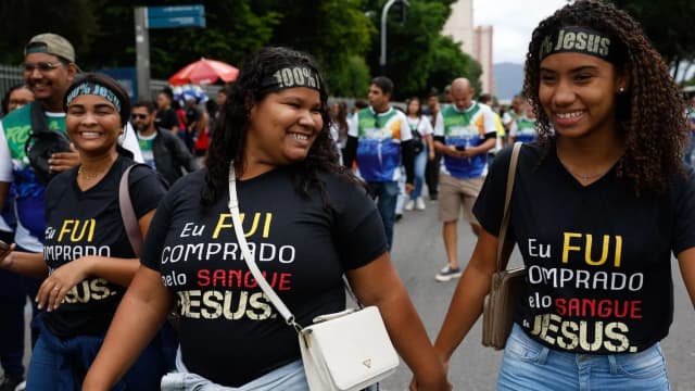 Mulheres evangélicas caminham em ato público usando camisetas com mensagens religiosas