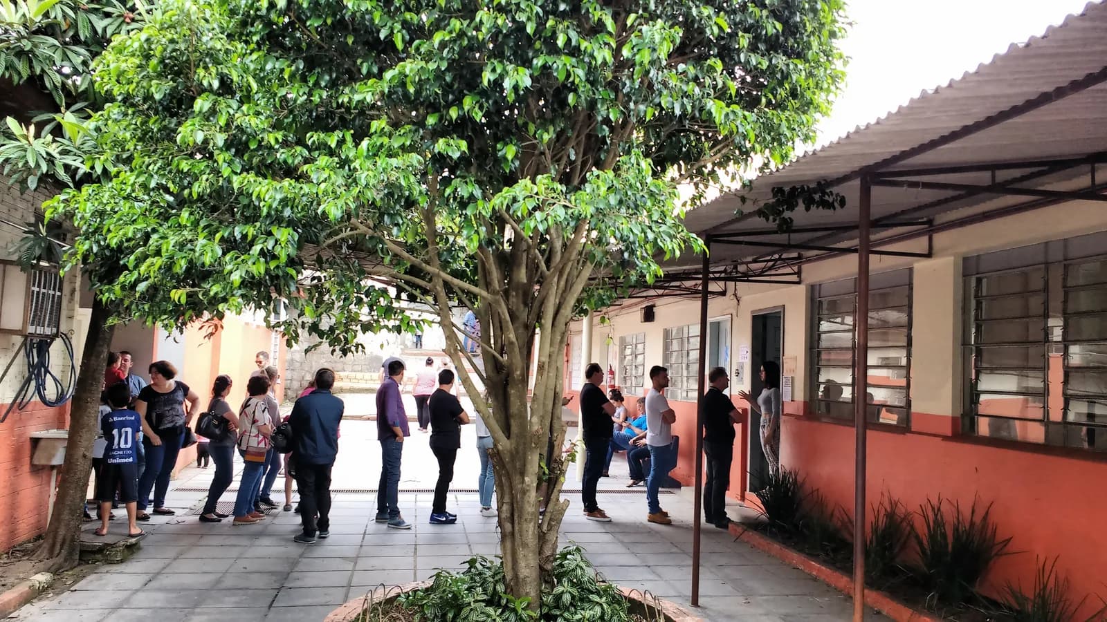 Fila de eleitores em frente a um local de votação no Brasil