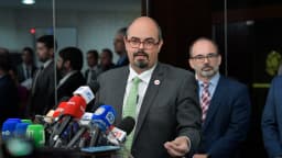 Mateus Simões fala em coletiva de imprensa cercado de microfones de emissoras mineiras