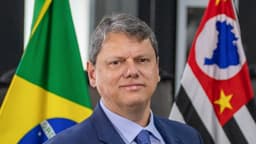 Tarcísio de Freitas, governador de São Paulo, em retrato oficial com bandeiras do Brasil e de São Paulo ao fundo