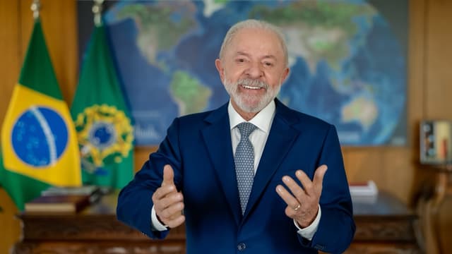 O presidente Luiz Inácio Lula da Silva, de terno azul, gesticula ao falar diante das bandeiras do Brasil e da Presidência da República, em foto de arquivo de novembro de 2025