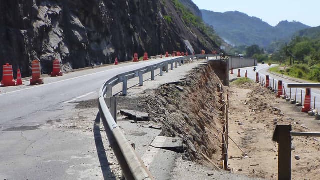 Trecho da BR-040 no Rio de Janeiro identificado como ponto crítico em levantamento da CNT, com erosão na pista e cones de sinalização (foto de arquivo, não é o local do acidente)