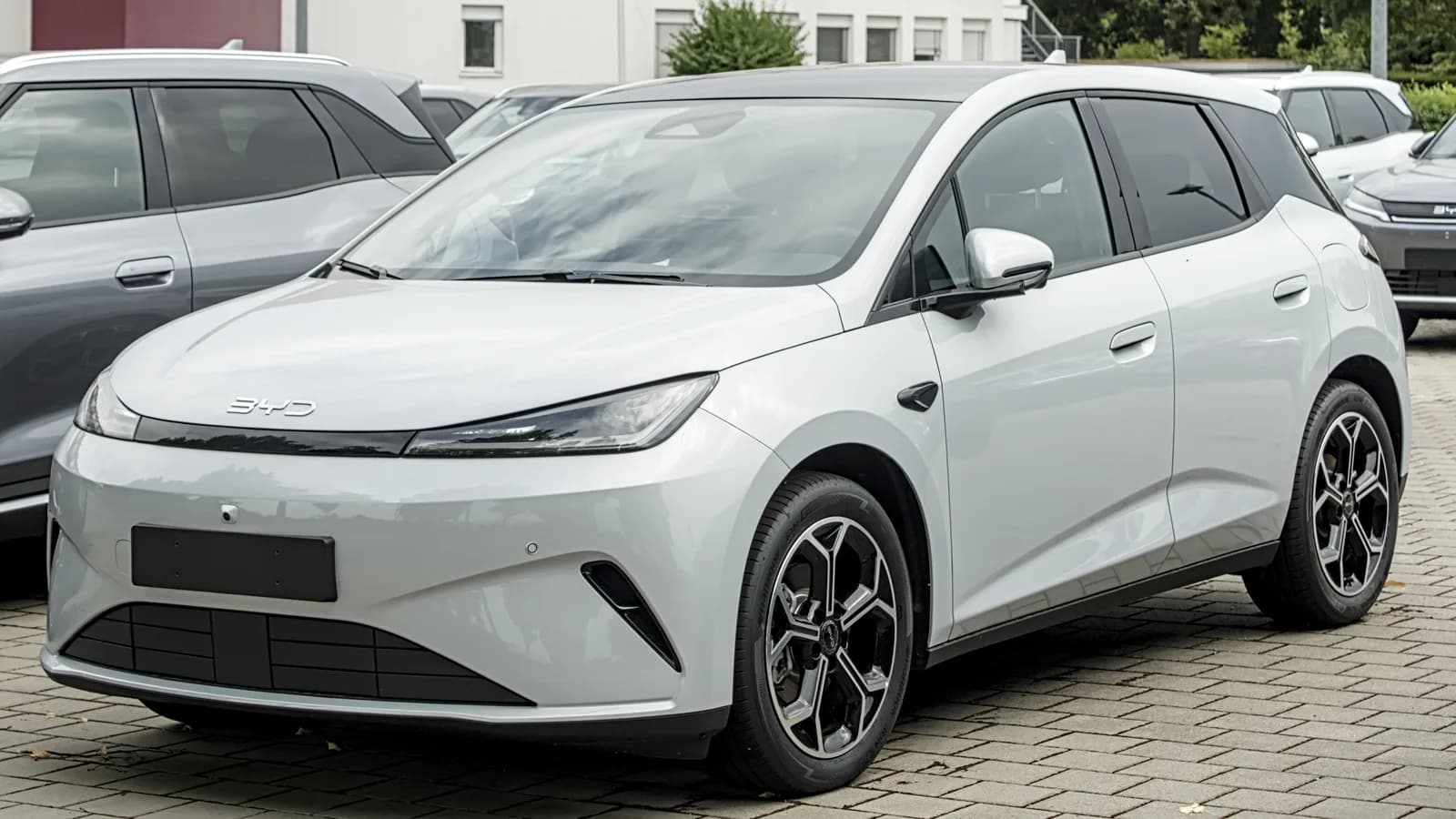 BYD Dolphin G branco estacionado, visto de frente em três quartos