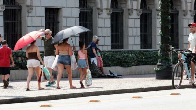 Pessoas caminham sob sol forte em imagem de arquivo no Rio de Janeiro
