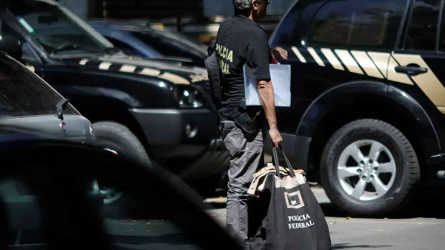 Agente da Polícia Federal carrega material durante operação
