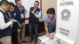 Observadores eleitorais acompanham a conferência de uma cabine de votação da Justiça Eleitoral