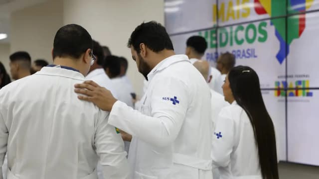 Médicos de jaleco branco com o símbolo do SUS em evento do programa Mais Médicos para o Brasil (imagem de arquivo)