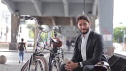 Gabriel Azevedo, candidato ao governo de Minas Gerais, ao lado de bicicleta sob viaduto em Belo Horizonte