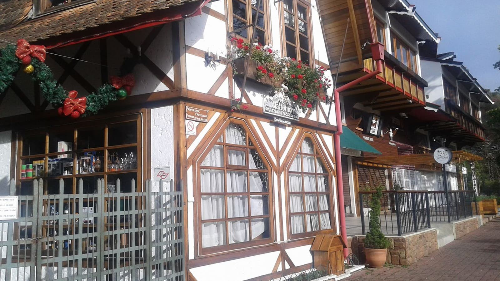 Fachada de restaurante em estilo europeu com estrutura de madeira aparente na Vila Capivari, Campos do Jordão