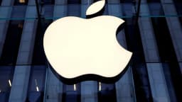 Logo da Apple iluminado na fachada de uma loja da marca