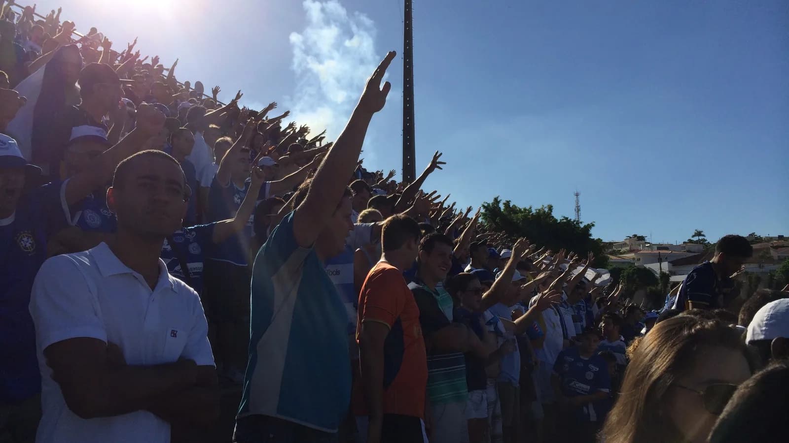 Torcedores em arquibancada de estádio de futebol brasileiro, com braços erguidos durante partida (foto de contexto, ilustrativa)