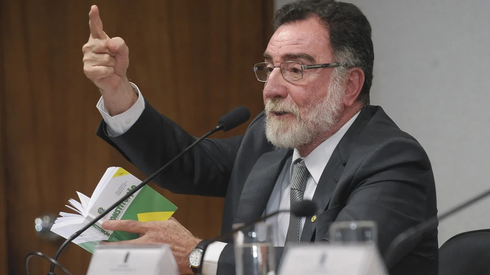 Patrus Ananias gesticula durante sessão no Senado, segurando documento