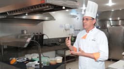 Chef de cozinha com touca branca em cozinha profissional, foto ilustrativa