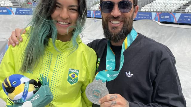 Raicca Ventura sorri ao lado de torcedor, exibindo medalha de skate