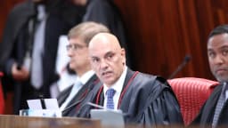 Alexandre de Moraes fala ao microfone durante sessão do TSE, vestindo toga