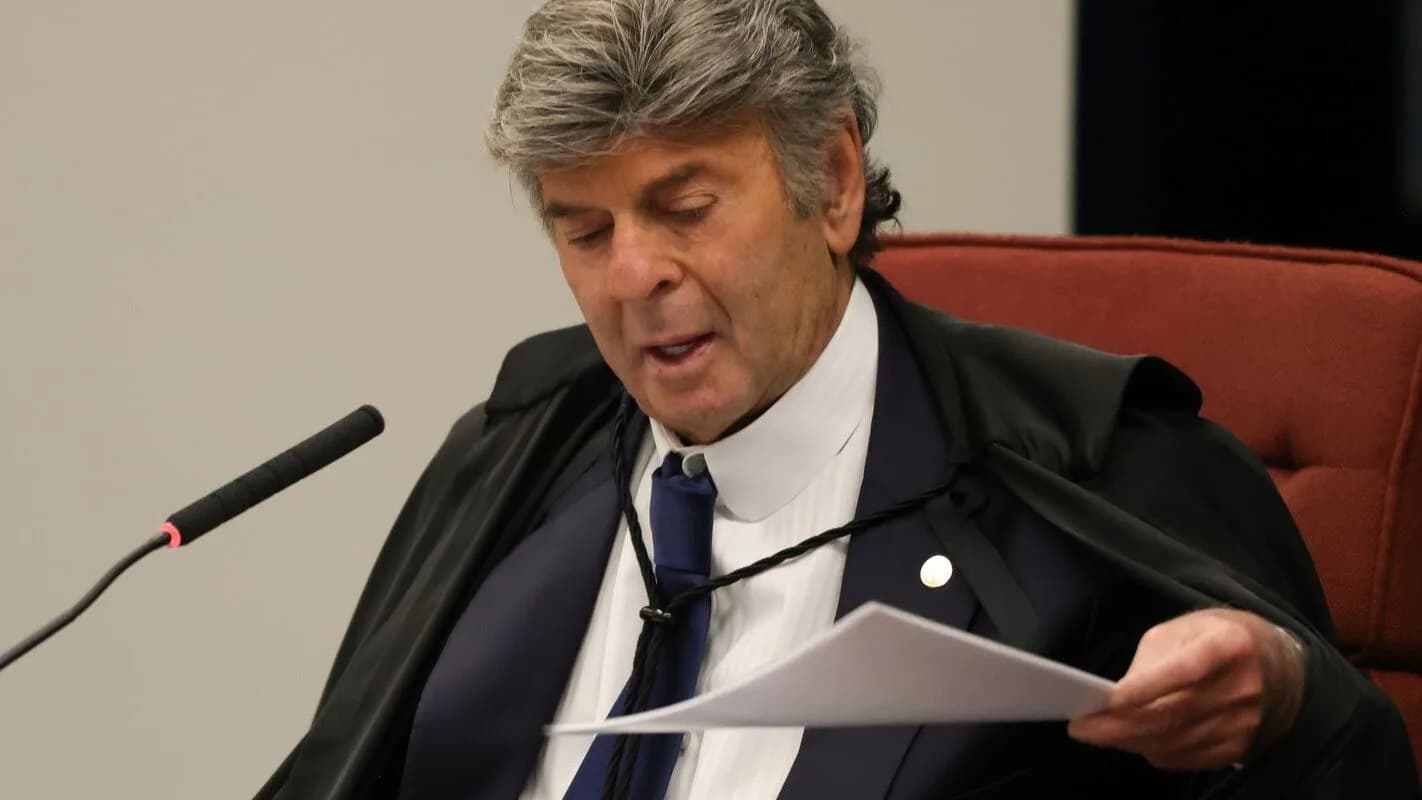 O ministro do STF Luiz Fux discursa segurando papéis durante sessão da Corte, vestindo toga