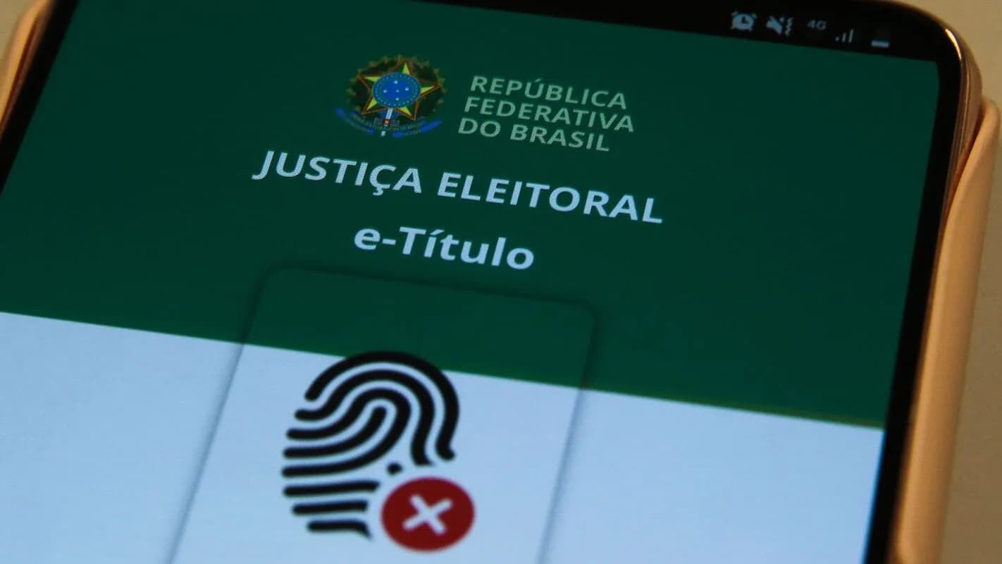 Tela de celular mostrando o aplicativo e-Título, da Justiça Eleitoral, com ícone de biometria digital