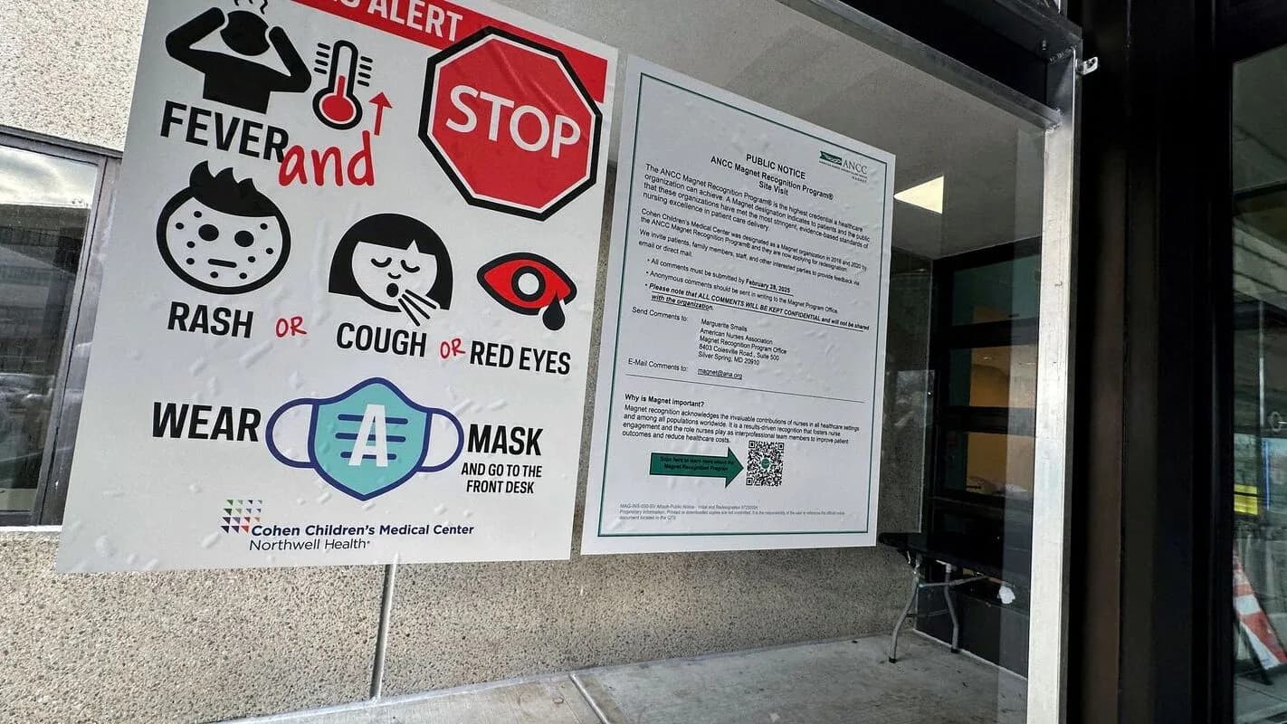 Cartaz de alerta sanitário em entrada de clínica, com símbolos de febre, erupção na pele, tosse e olhos vermelhos, recomendando uso de máscara