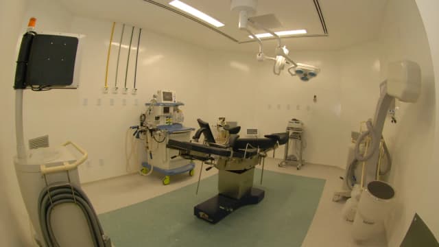 Sala de cirurgia equipada, com mesa cirúrgica e aparelhos médicos