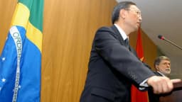 Celso Amorim discursa ao lado da bandeira do Brasil em encontro diplomático