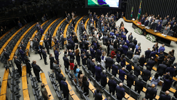 Plenário da Câmara dos Deputados lotado durante sessão solene, com parlamentares em pé