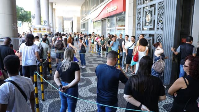 Fila de candidatos aguarda para entrar em local de prova de concurso público