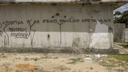 Grafite em muro de prédio abandonado cobra justiça para famílias afetadas e critica a Braskem, em área do afundamento do solo em Maceió (AL)