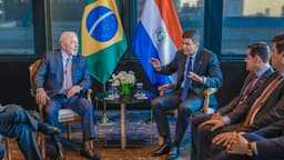 Foto de arquivo de 2023: o presidente Lula e o presidente do Paraguai, Santiago Peña, sentados frente a frente durante reunião, com as bandeiras do Brasil e do Paraguai ao fundo