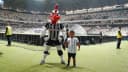 Mascote do Atlético-MG e criança no gramado da Arena MRV, com torcida nas arquibancadas