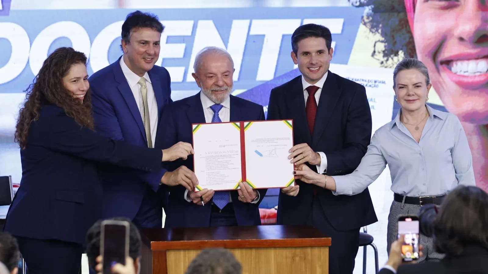 Presidente Lula segura documento assinado ao lado de ministros durante cerimônia de sanção no Planalto (foto de arquivo)