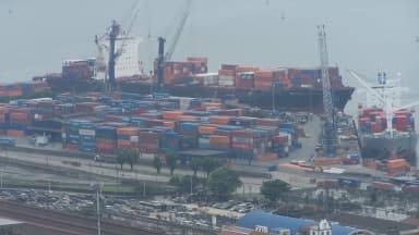 Vista aérea do Porto de Santos com navios porta-contêineres e pátio de cargas
