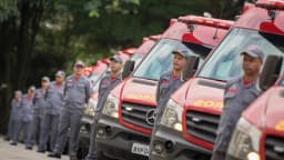 Fileira de viaturas do Corpo de Bombeiros de São Paulo com equipes perfiladas, em foto de arquivo