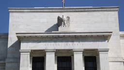Fachada do Federal Reserve, em Washington, com a bandeira dos Estados Unidos