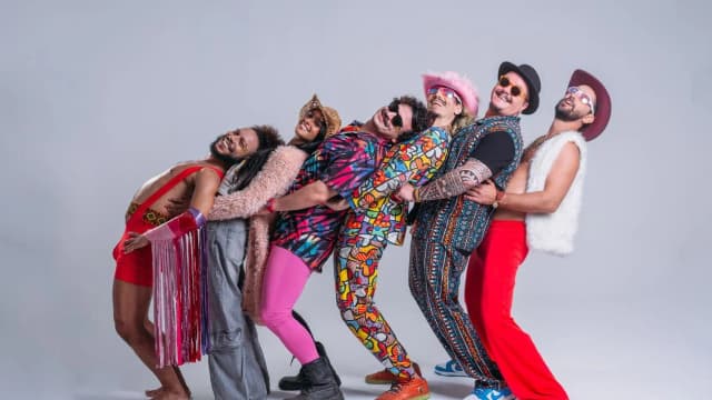 Grupo de integrantes de bloco de carnaval em pose animada e colorida