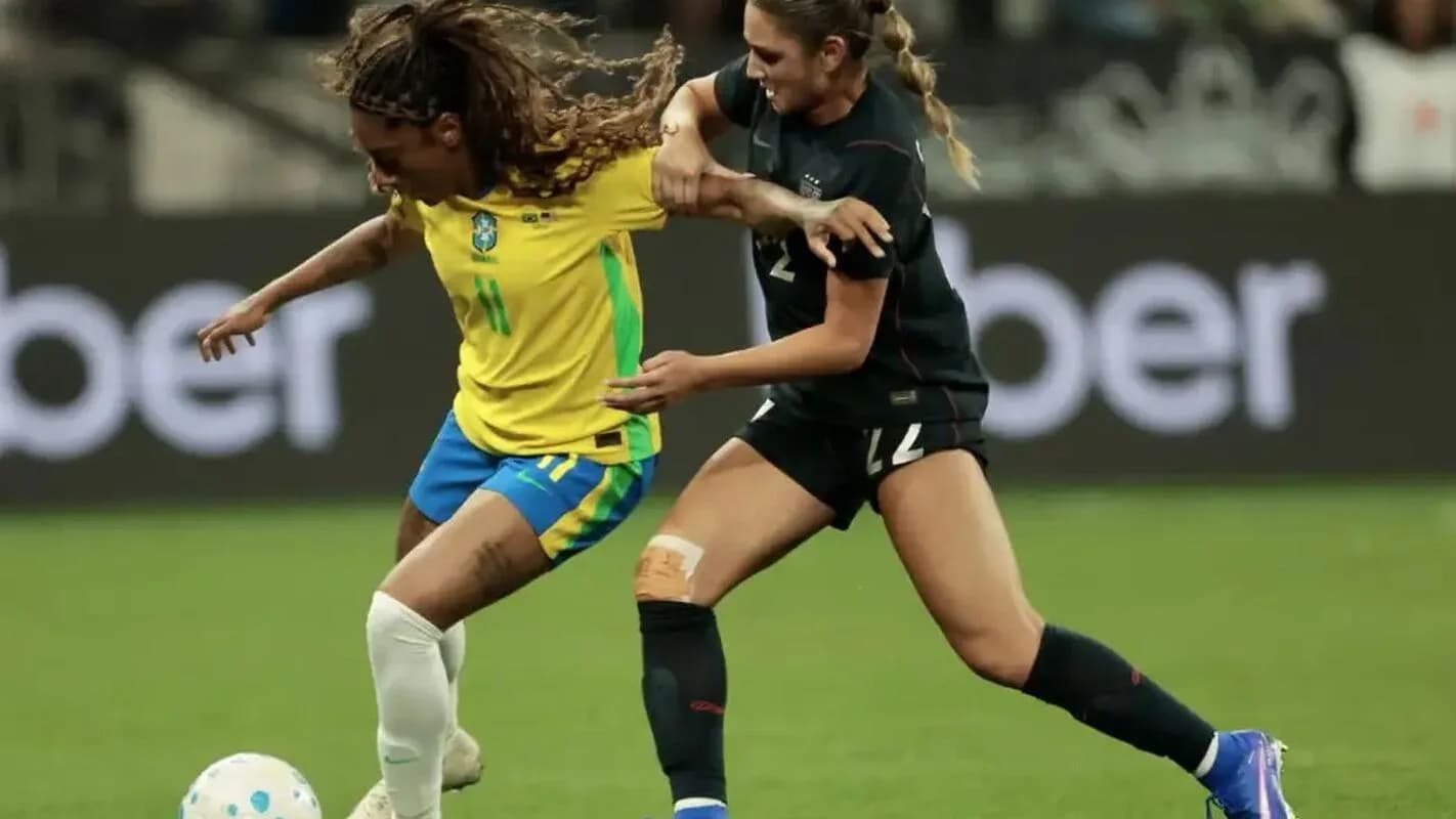 Jogadoras de futebol feminino em disputa de bola durante partida