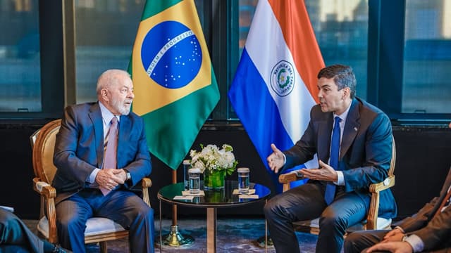 Foto de arquivo: os presidentes Lula, do Brasil, e Santiago Peña, do Paraguai, sentados frente a frente durante encontro bilateral, com as bandeiras dos dois países ao fundo