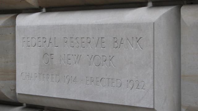 Fachada do edifício do Federal Reserve Bank of New York, com placa de pedra gravada com o nome da instituição