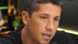 Thiago Carpini fala durante entrevista, com microfone à frente
