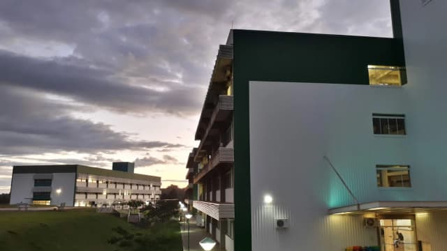 Fachada de prédio de universidade federal (UFFS) ao entardecer, com luzes acesas