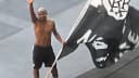 O lateral Cuiabano acena para a torcida do Botafogo segurando uma bandeira do clube no Nilton Santos