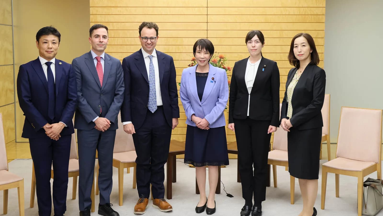 Dario Amodei posa ao lado da primeira-ministra do Japão, Sanae Takaichi, e outras autoridades