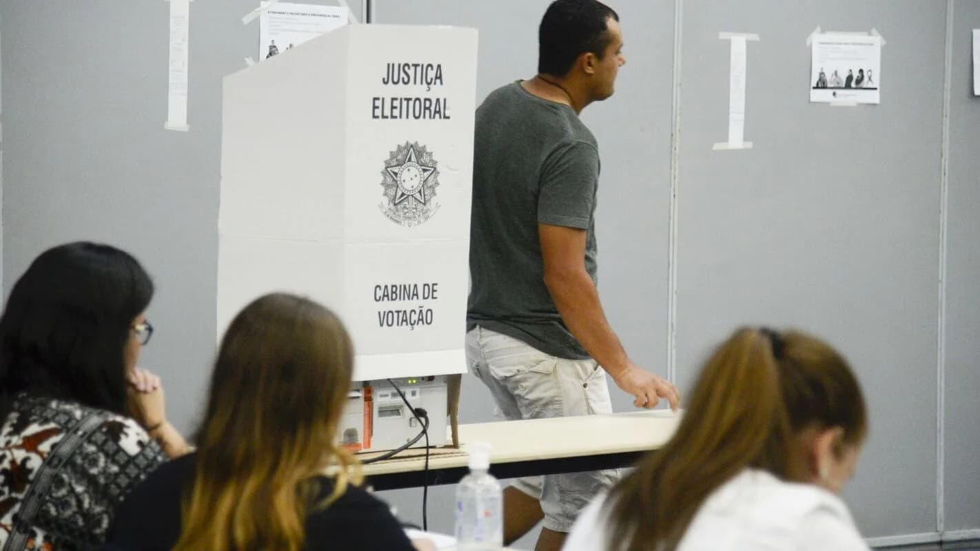 Eleitores votam em cabine da Justiça Eleitoral pouco antes do fim da votação