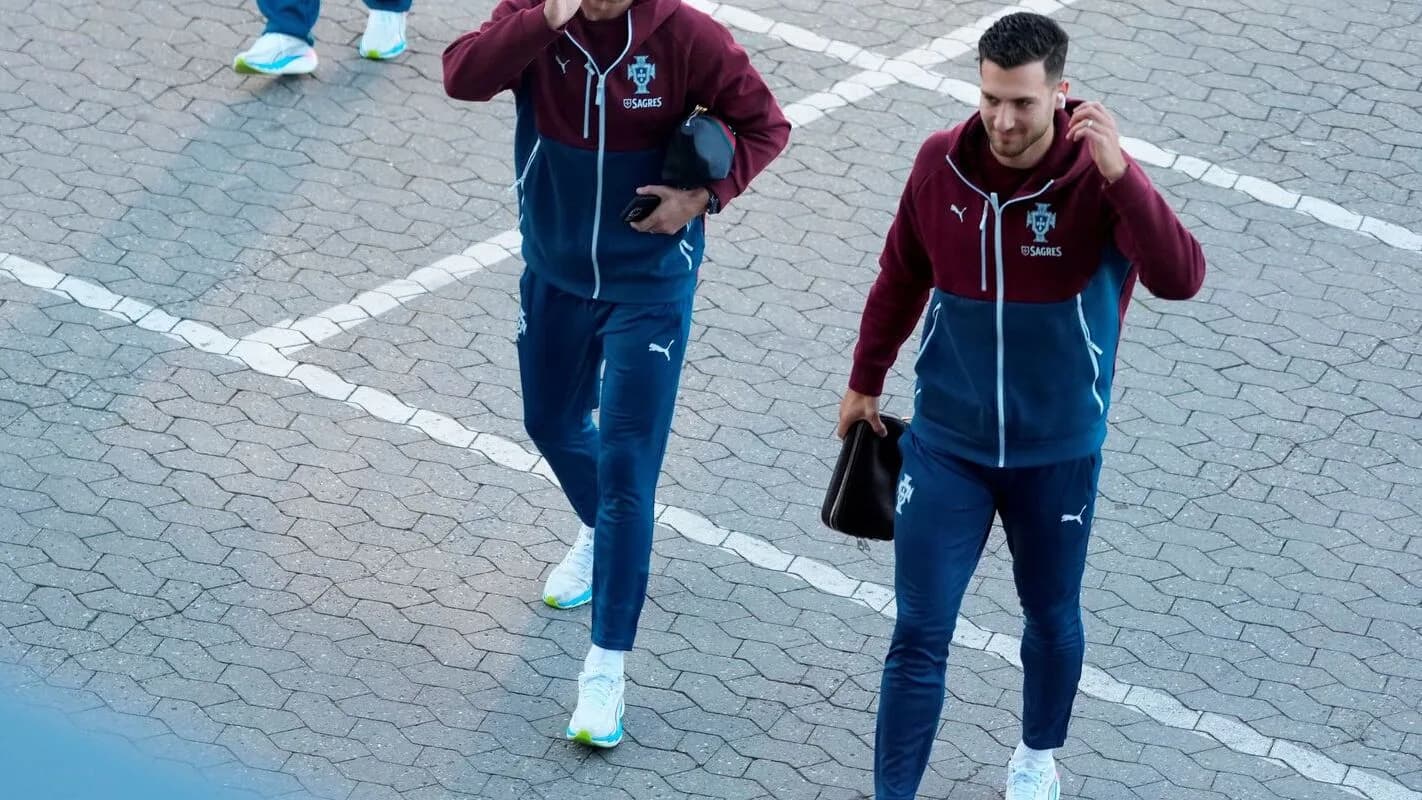 Jogadores da seleção de Portugal caminham após deixar o hotel de concentração