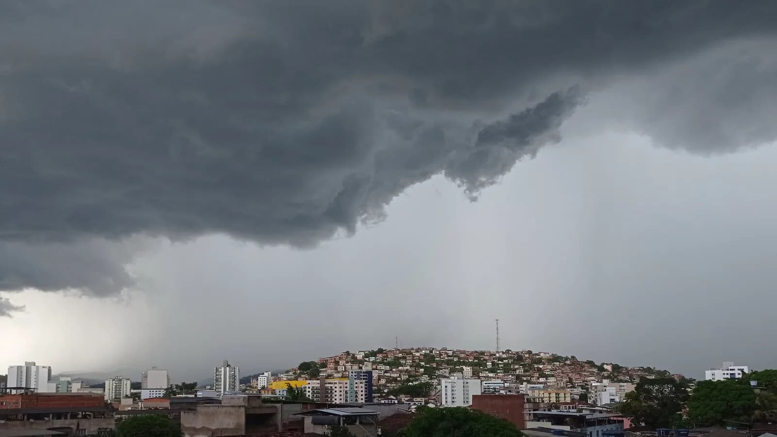 Nuvens escuras de temporal se aproximando sobre área urbana
