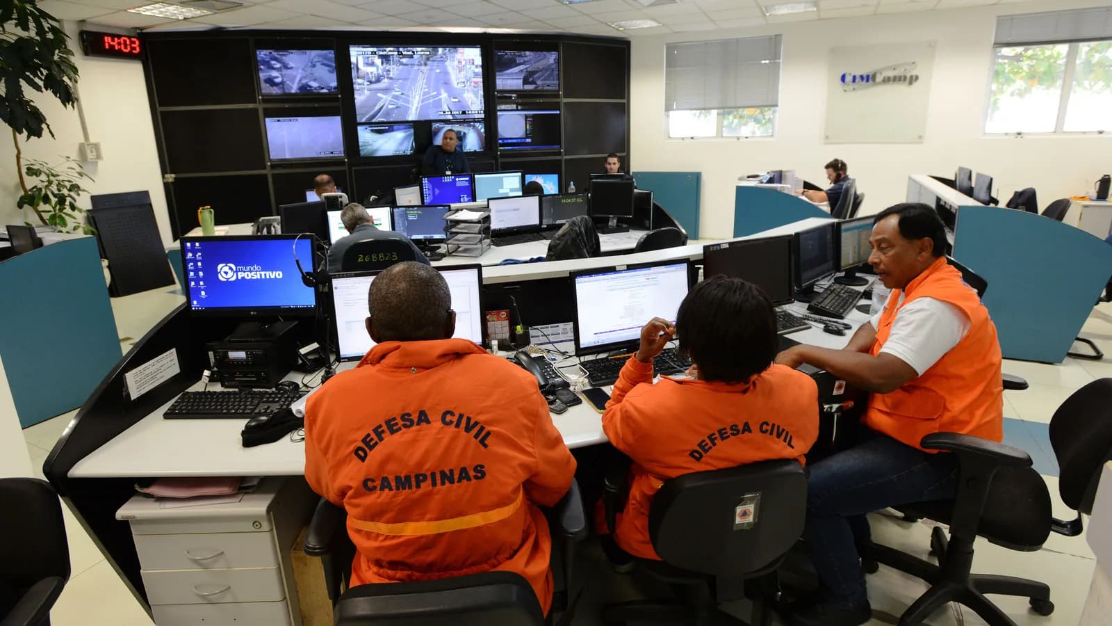 Operadores da Defesa Civil de Campinas monitoram câmeras de segurança em central de monitoramento