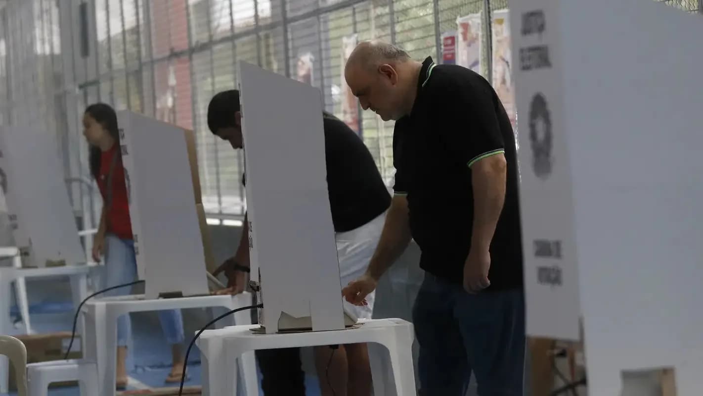 Eleitores votando em cabines eleitorais durante o pleito