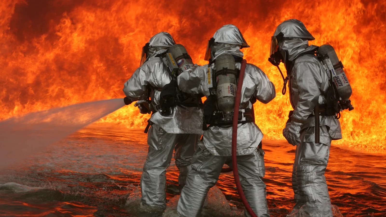 Bombeiros em treinamento de combate a incêndio com uniforme de proteção térmica (foto ilustrativa)