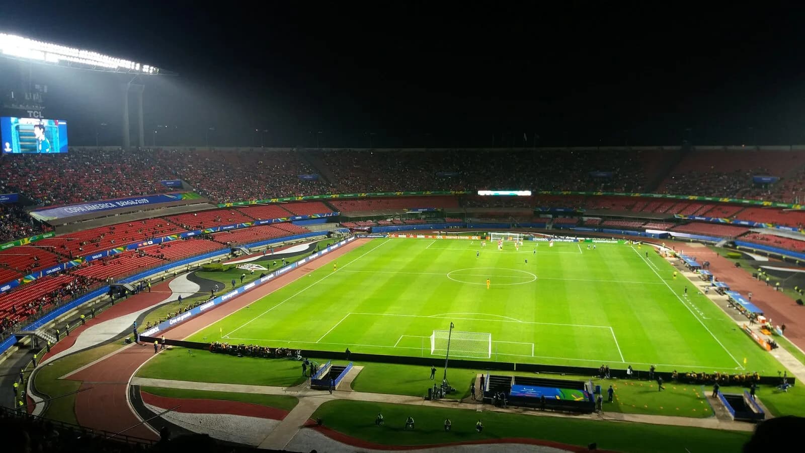 Estádio do Morumbi iluminado durante partida de futebol à noite