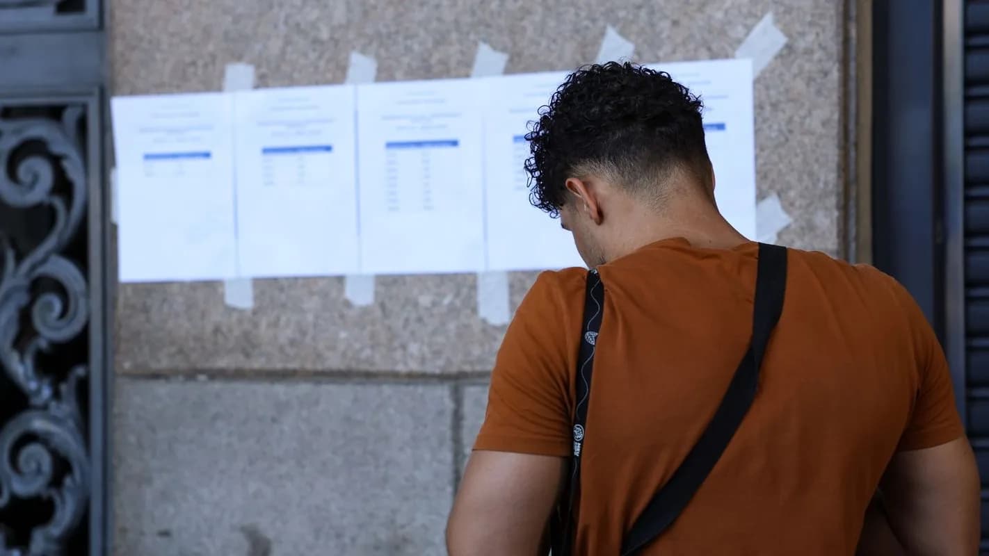 Candidato consulta lista de resultado de concurso público afixada em parede (foto de arquivo, ilustrativa)