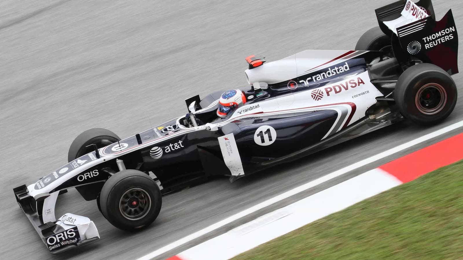 Rubens Barrichello pilotando carro de Fórmula 1 em pista de corrida